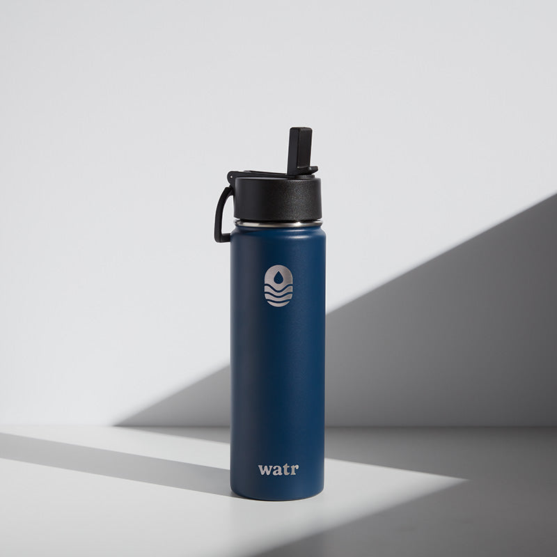 A blue 22 oz water bottle with a black lid and a straw, branded with the name &