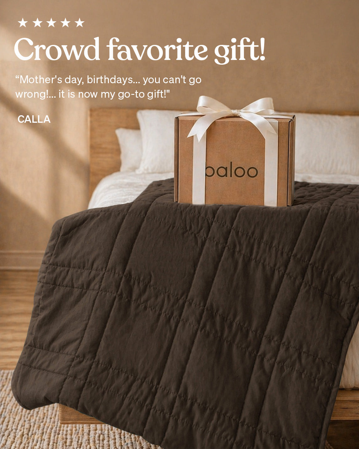 Box with a white ribbon on a bed, labeled &