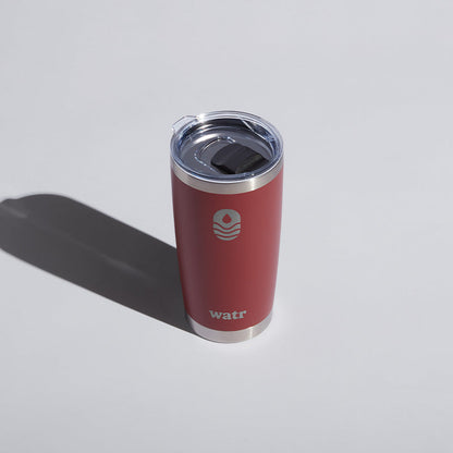 Alt text: &quot;Red 20 oz WATR branded tumbler with a clear sliding lid, prominently featuring the company&