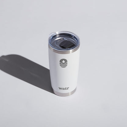 White 20 oz WATR Tumbler with a transparent lid, featuring a minimalist logo design, displayed on a light background with a distinct shadow.