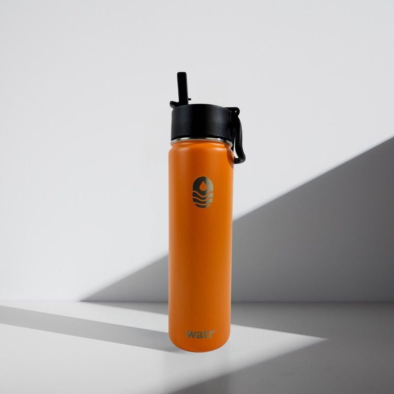 Orange water bottle with black lid on a gray background