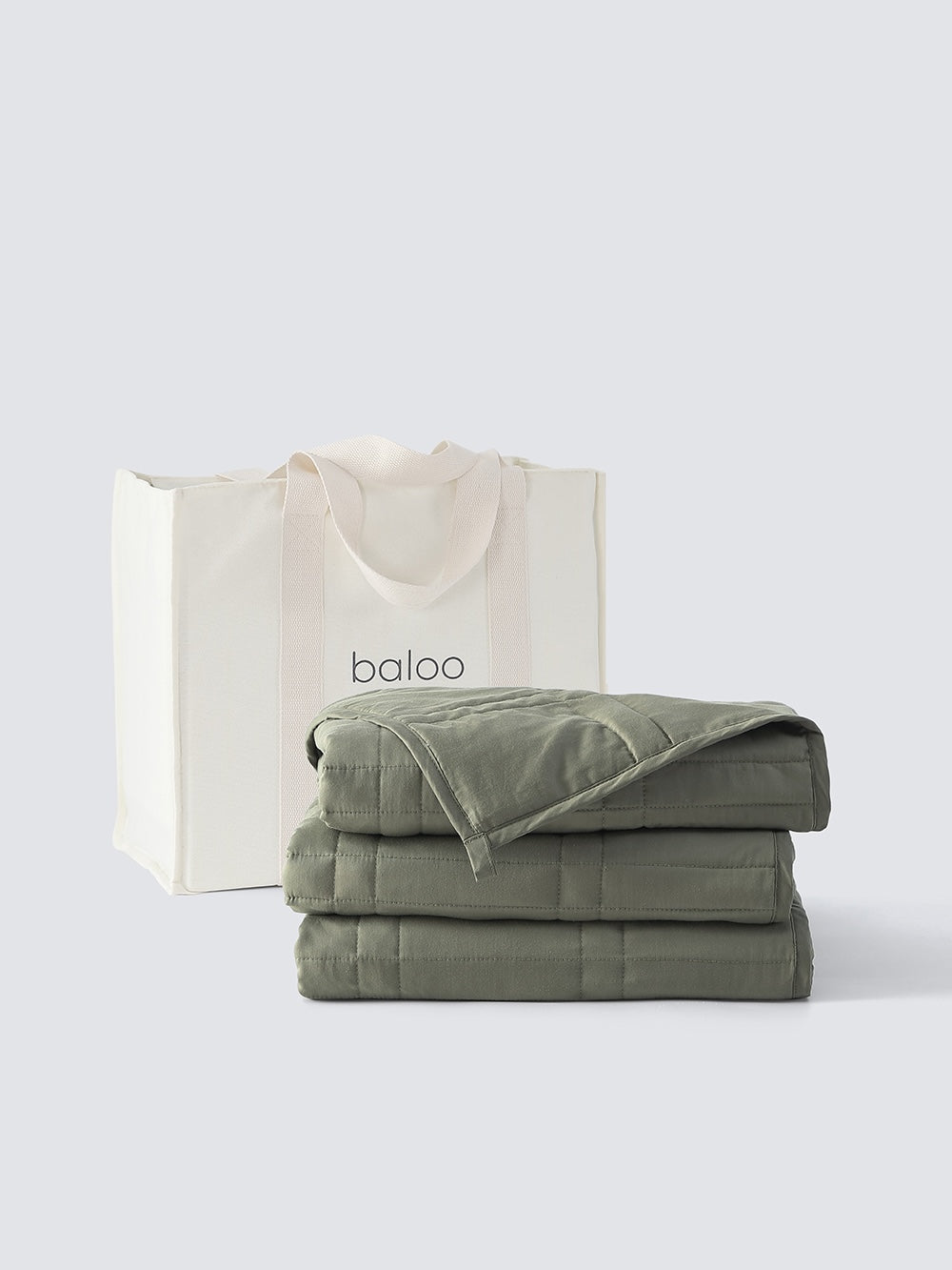 Folded weighted blanket in front of a white canvas tote [47867971961051, 47867972124891, 47867972223195, 47867972321499]