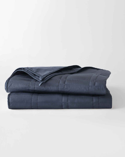 folded weighted blanket in luna blue against an empty background [43649942782171, 45574417875163, 44422804340955, 45574418137307, 44422811287771, 46452818510043, 44422816432347, 46452819067099, 46061921468635, 46061921501403, 46061921534171, 46063267643611, 46063269052635, 47185819762907, 47185819992283, 47185820025051, 47185820123355]