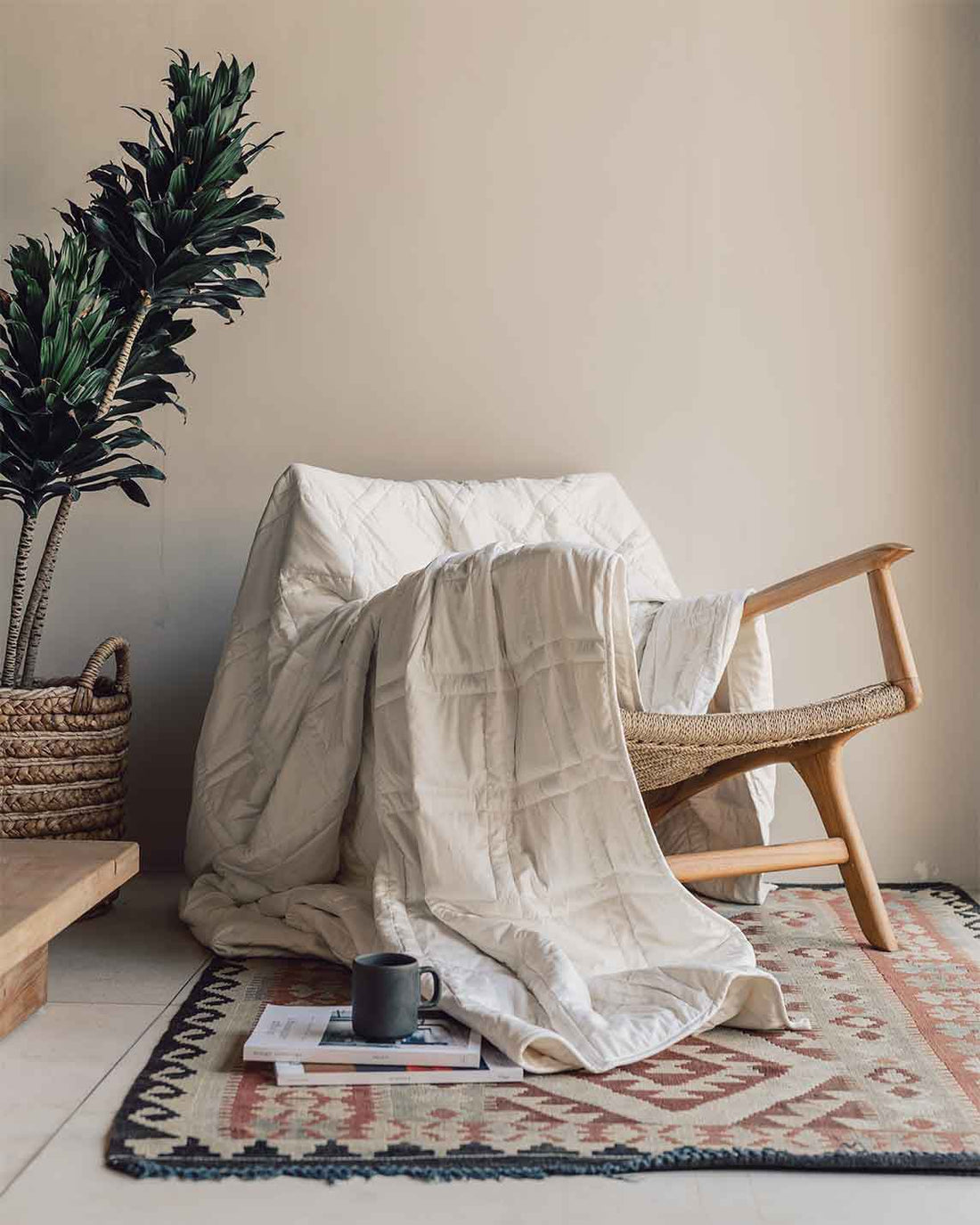 A luxurious looking white cotton weighted blanket drapes across a chair, next to a coffee mug on the floor and a plant. [42934587818203, 45574417940699, 42934587850971, 46452818444507, 47185819795675, 47185819861211, 46301293478107, 46301293576411, 46301293641947, 46301293707483, 42934587883739, 48114590777563, 48114638913755, 45574417809627]