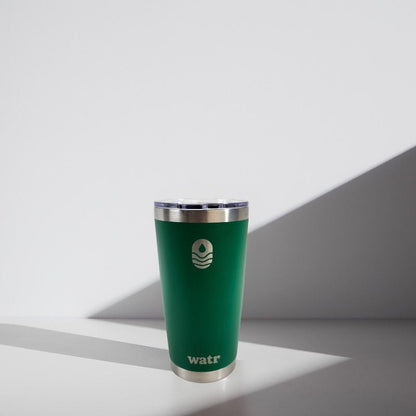 Green tumbler with silver lid on a white background