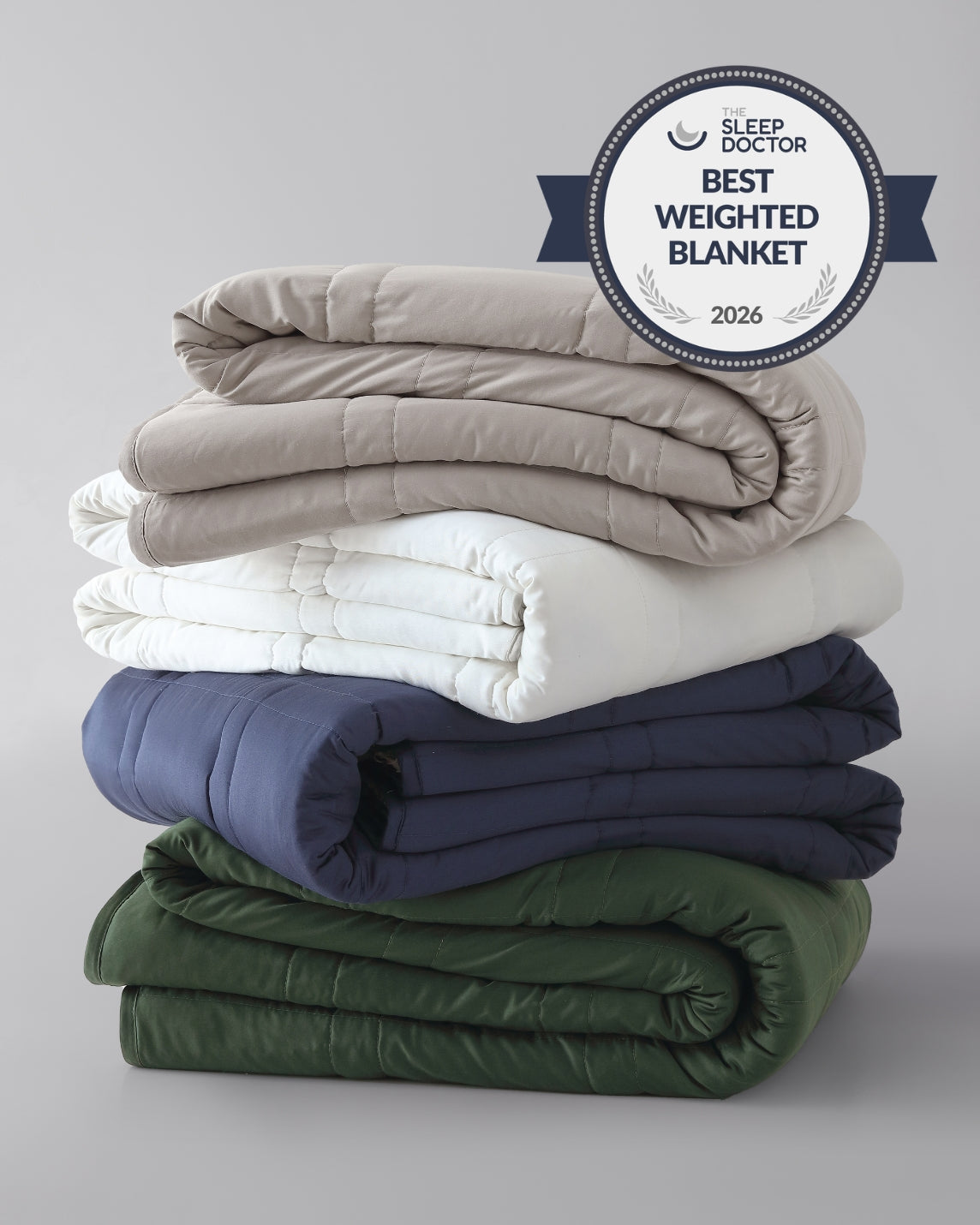 A stack of folded weighted blankets in the colors pebble white, silver sage, and luna blue. [42934587621595, 45574417809627, 45574417940699, 46452819001563, 43690188472539, 46452818444507]