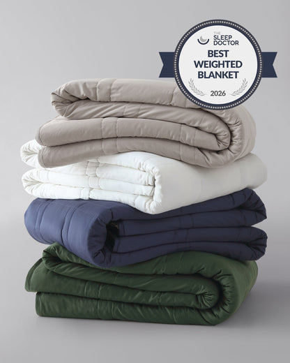 A stack of folded weighted blankets in the colors pebble white, silver sage, and luna blue. [42934587621595, 45574417809627, 45574417940699, 46452819001563, 43690188472539, 46452818444507]