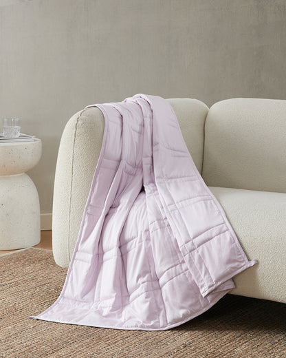 lavender weighted blanket draped over an ivory sofa [47867972059355, 47868894937307, 47868894970075, 47868895002843, 47868895035611, 47868895854811, 47868895887579, 47868895920347, 47879290454235]