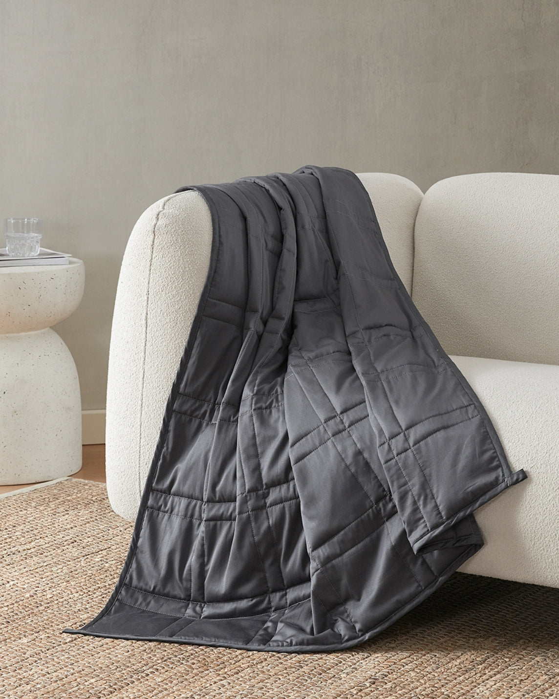 midnight weighted blanket draped over the arm of an ivory sofa  [47867971993819, 47867972157659, 47867972255963, 47867972354267, 47868867870939, 47868894675163, 47868894707931, 47868894740699, 47868894773467, 47868895658203, 47868895690971, 47868895723739]