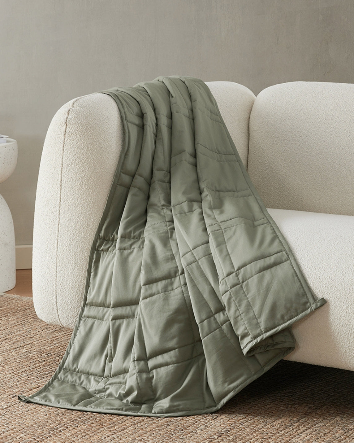 moss green weighted blanket draped over the arm of an ivory sofa [47867971961051, 47867972124891, 47867972223195, 47867972321499, 47868894544091, 47868894576859, 47868894609627, 47868894642395, 47868895559899, 47868895592667, 47868895625435]